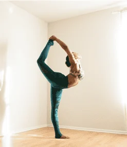 Woman stretching with leg over head