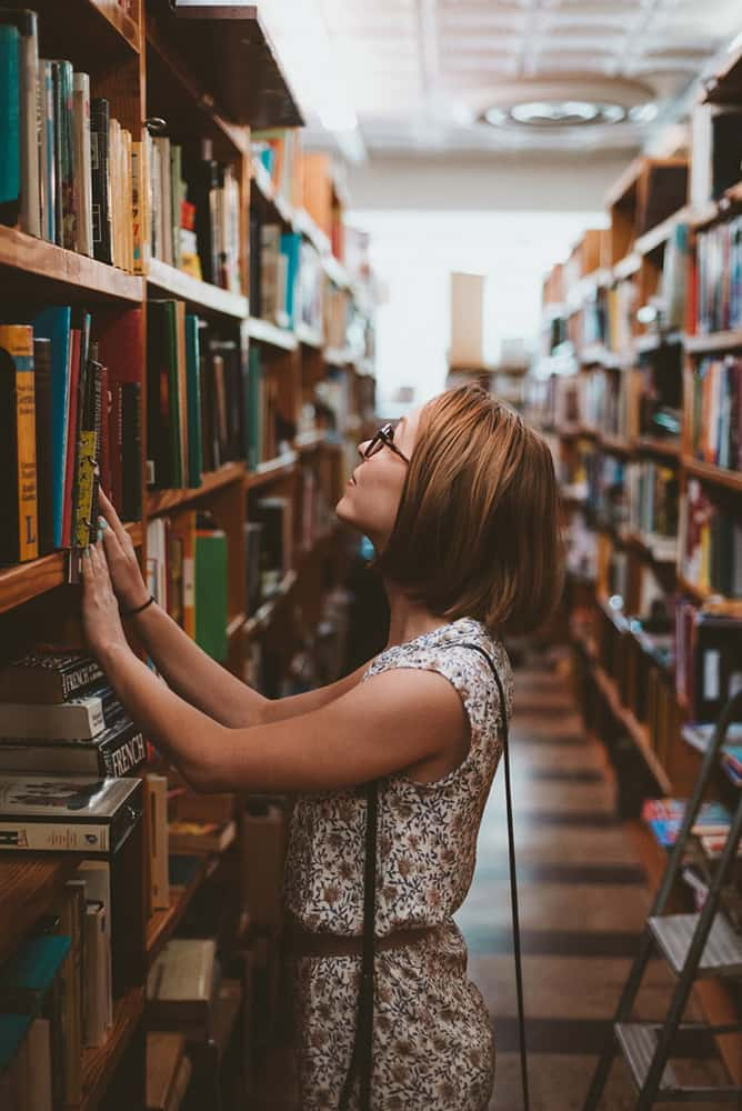 Student looking at books in the library